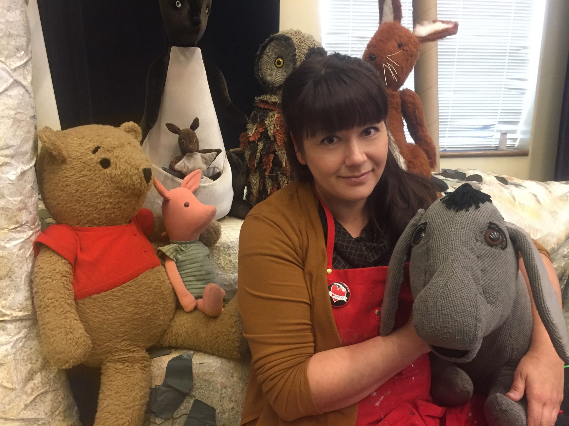 MTYP Head of Properties Janelle Regalbuto surrounded by puppets from The House at Pooh Corner